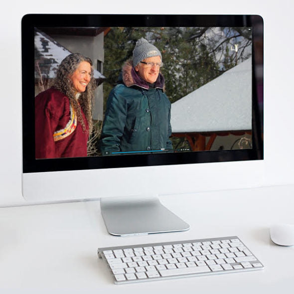 White computer monitor with photo of Lama Tsomo and Matthew Fox outdoors